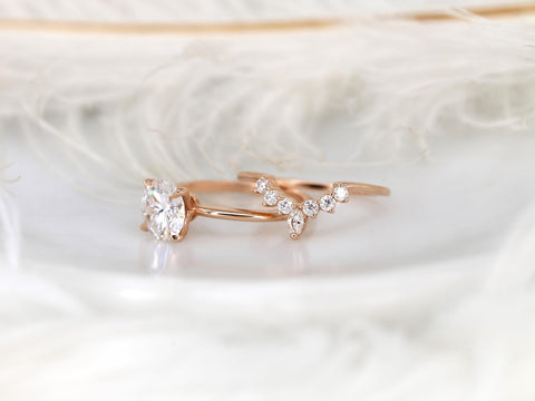 round engagement wedding ring set in rose gold with a complimentary unique curved ring on white background separated from side