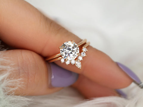 round solitaire moissanite paired with a unique diamond nesting band in 14kt rose gold on finger