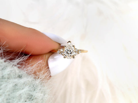 pear cut cluster diamond ring pinched between fingers