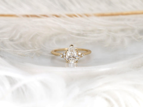 pear cluster ring with yellow gold on white background with feathers front view