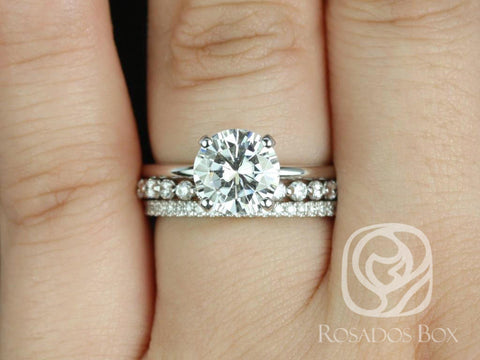 Bridal set featuring a 2ct round moissanite solitaire with hidden halo and diamond-accented bands on finger