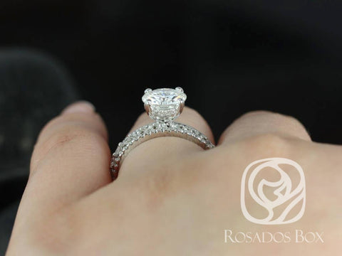 Round moissanite engagement ring with hidden halo and diamond-accented band in 14kt gold bridal set on finger