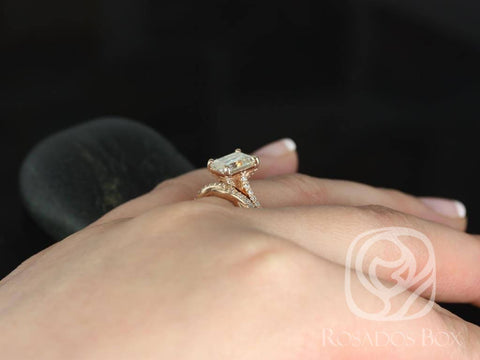 Emerald cut moissanite twist bridal set in 14kt gold worn on a finger