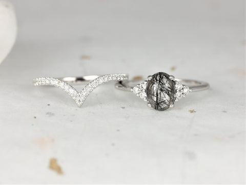 14kt gold bridal set with oval tourmalinated quartz center and diamond accent wedding band on light surface