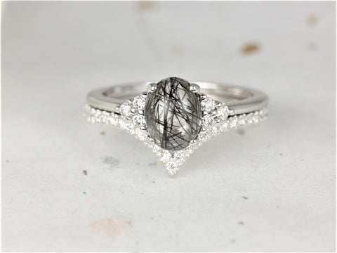 Oval tourmalinated quartz center stone with diamond accents on 14kt gold bridal ring set against light background