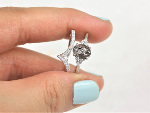 14kt gold bridal set with oval tourmalinated quartz center and diamond accents held between fingers