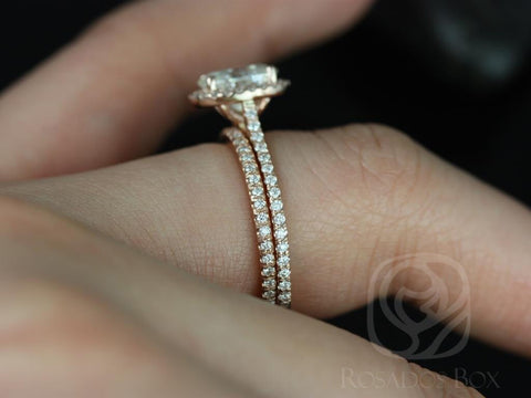 14kt gold bridal set with oval moissanite center and diamond-accented band worn on finger in natural light