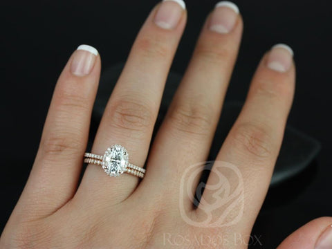 Dainty 14kt gold bridal set with oval halo moissanite and diamond-accented wedding band on hand