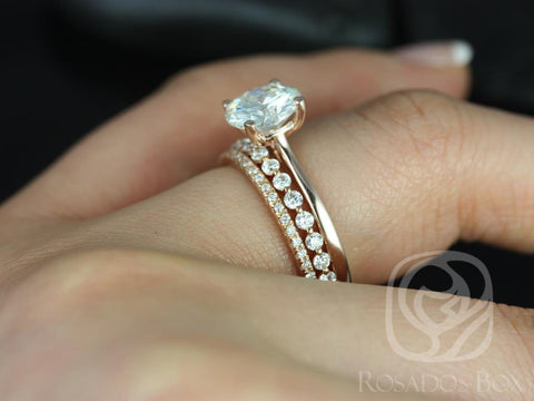 14kt gold bridal set featuring slender bands with round moissanite solitaire and pavé diamond accents on finger