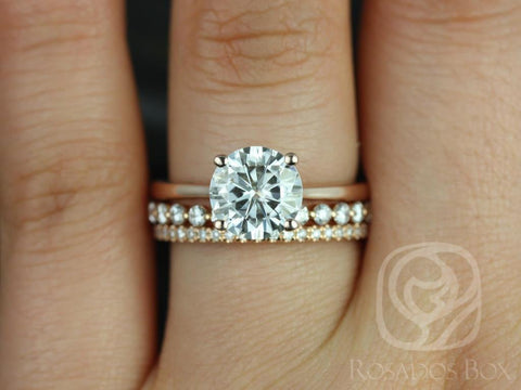 14kt gold bridal set with round moissanite solitaire and pavé diamond-accented wedding bands on finger