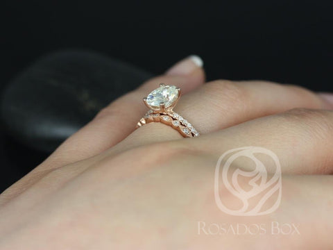 Rose gold bridal set featuring oval moissanite solitaire and diamond-accented wedding band on hand