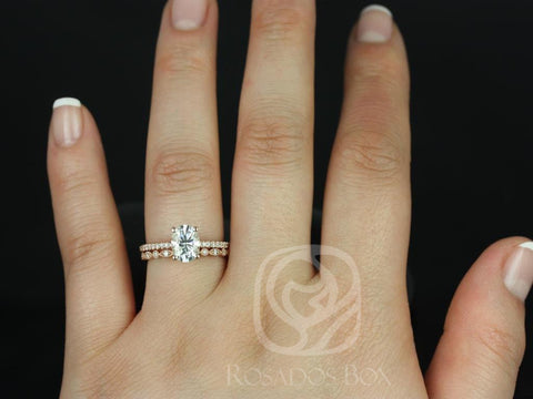 Rose gold bridal set with oval moissanite center stone and pavé diamond accent wedding band on hand against black background