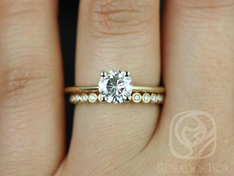 14kt gold solitaire bridal set with a round moissanite center and petite diamond bubble band on finger