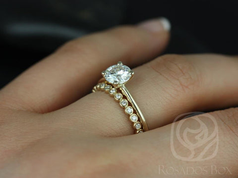 14kt gold bridal set with 6.5mm round moissanite solitaire and petite bubble diamond-accented wedding band on finger