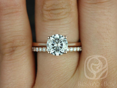 14kt gold bridal set featuring a slim band with pavé diamonds and a round moissanite solitaire ring on finger