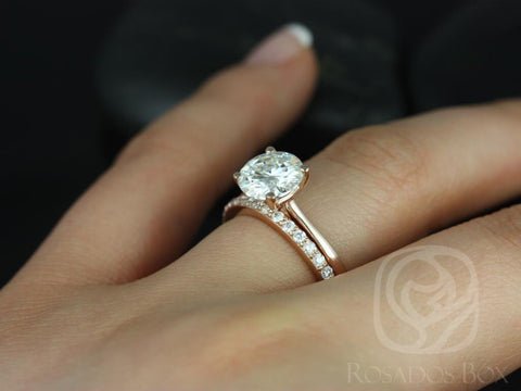 14kt gold moissanite bridal set with round solitaire and diamond-accented wedding band on finger