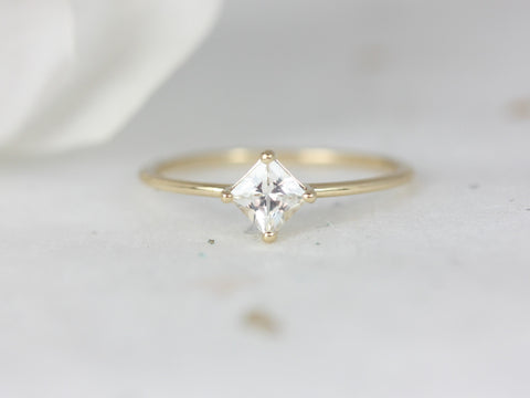 14kt white sapphire princess cut kite set ring displayed on a light surface