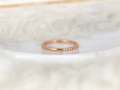 Rose gold ring with small diamonds on a white fur background