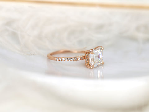 east west set emerald cut solitaire with diamonds on band on white background sideview