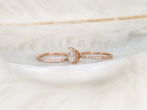 east west set emerald cut solitaire with diamonds on shank and matching diamond band on white background sideways far