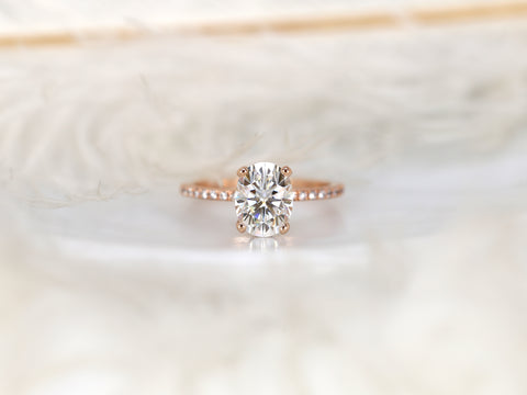 oval solitaire with diamond accents on white background