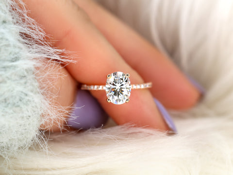oval solitaire with diamond accents on pointer finger