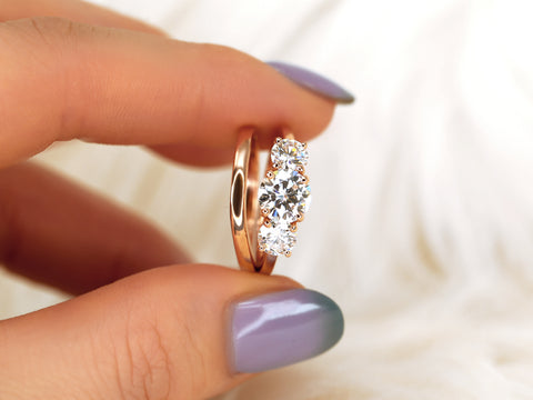 three stone ring wedding set pinched between fingers
