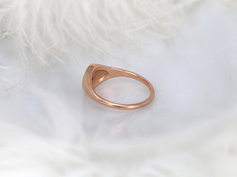 Rose gold band with a subtle star-shaped setting displayed on a soft white textured background