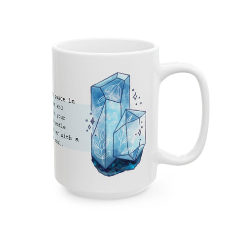 White mug with blue crystal illustration and partial inspirational text on a clean white background