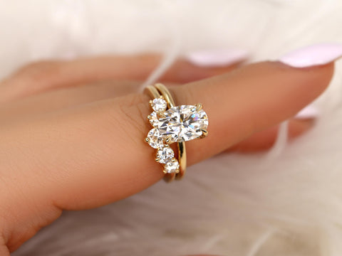 Gold bridal set featuring an oval moissanite solitaire ring paired with a curved diamond accent band