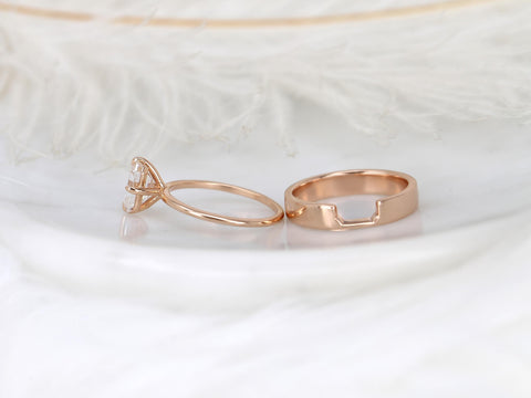 Rose gold bridal set with emerald cut solitaire moissanite and matching wedding band on soft white background