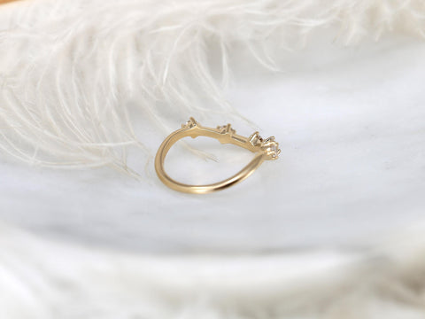 Delicate 14kt gold ring with a row of small diamonds set in a curved band, styled against soft white feathers