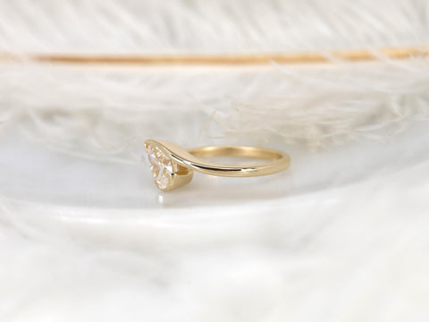 14kt gold ring featuring a tilted pear-shaped moissanite solitaire on a slender band for elegant fine jewelry