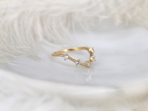 Delicate gold ring with a unique open chevron design set with small sparkling diamonds on a soft background