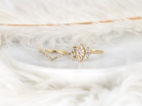 Moissanite marquise three-stone ring paired with a delicate curved diamond-accented gold wedding band bridal set