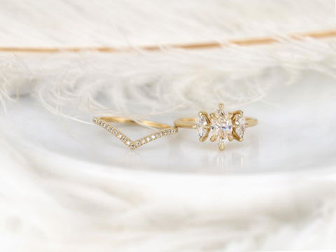 Three-stone marquise moissanite ring paired with a delicate curved diamond-accented 14kt gold wedding band
