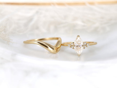 Elegant 14kt gold bridal set featuring a marquise moissanite engagement ring with a matching curved wedding band.