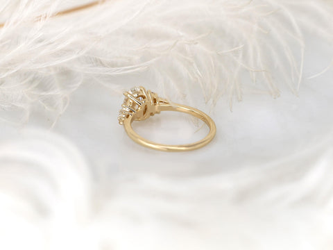 Gold ring with diamonds on a white feather background