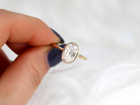 oval rose cut ring between finger in yellow gold