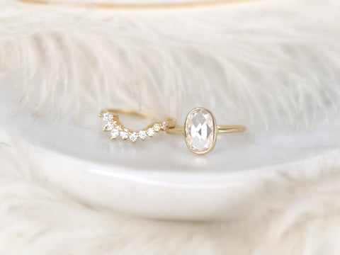 moissanite rose cut ring in oval cut paired with unique curved diamond band on white background