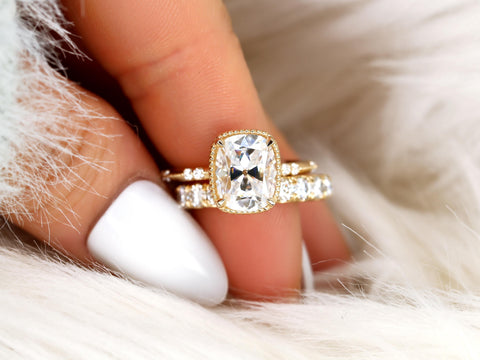 antique cushion cut button back ring with accent diamonds paired with a thick diamond band on pointer finger