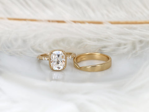 antique cushion solitaire with button back, claw prongs, and diamond accents on band. the ring is paired with a chevron solid gold band on white background front view