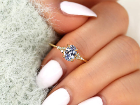 oval cornflower lilac sapphire cluster ring with dainty diamonds on middle finger