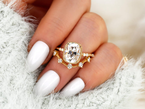 antique cushion engagement ring with button back paired with a curved diamond spaced band on ring finger