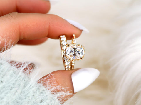 antique cushion cut button back ring with accent diamonds paired with a thick diamond band between pointer and thumb