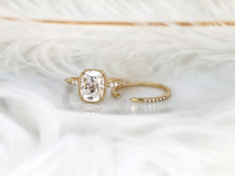 antique cushion button back ring with milgrain edge paired with a open diamond band with pointed opening on white background