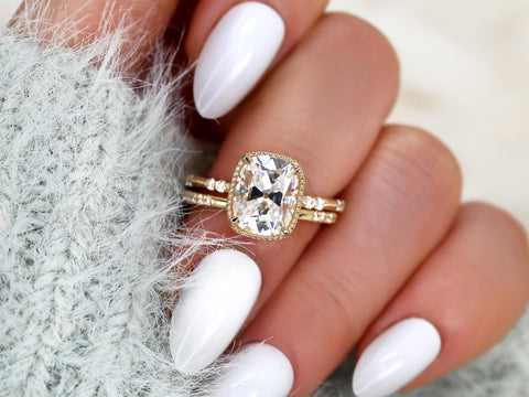 antique cushion button back ring with milgrain edge paired with a open diamond band with pointed opening shown on middle finger over light blue sleeve