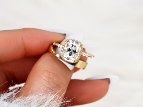 antique cushion solitaire with button back, claw prongs, and diamond accents on band. the ring is paired with a chevron solid gold band pinched