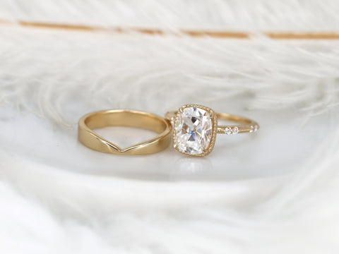 antique cushion solitaire with button back, claw prongs, and diamond accents on band. the ring is paired with a chevron solid gold band on white background angled