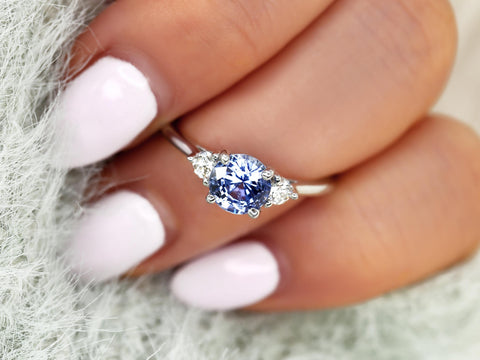 cornflower blue sapphire trilogy ring on ring finger and over seafoam sleeves